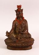 A CHINESE BRONZE FIGURE OF SEATED BUDDHA / DEITY - in a seated pose upon pedestal holding objects,