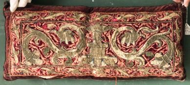 A 17TH/18TH CENTURY SPANISH OR ITALIAN GOLD EMBROIDERED VELVET PILLOW, 22in x 9in.