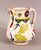 A TURKISH KUTAHYA POTTERY DECORATED JUG - decorated with multi colour glaze to depict flora - 14cm