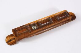 A JERUSALEM OLIVE WOOD SCROLL HOLDER with velum manuscript inside, 21cm long.