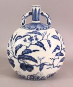 A CHINESE MING STYLE BLUE AND WHITE TWO HANDLED MOON FLASK, the body painted with peach trees,