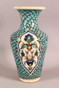A TURKISH MARKET GLAZED POTTERY VASE, the body painted with fish scale decoration and floral motifs,