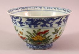 A CHINESE UNDERGLAZE BLUE WUCAI DECORATED PORCELAIN BOWL - decorated with ducks and flora - with