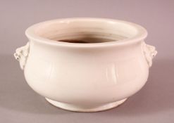 A CHINIESE BLANC DE CHINE PORCELAIN TWIN HANDLE CENSER - with twin moulded lion dog handles - the