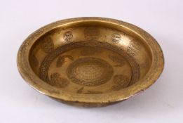 A FINE 18TH CENTURY INDO PERSIAN ENGRAVED BRASS MAGIC BOWL, the interior with calligraphy boteh