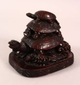 A CHINESE CARVED / MOULDED FIGURE OF THREE TURTLES AMONGST WAVES - 10cm