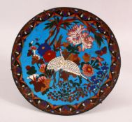 A JAPANESE CLOISONNE DISH, decorated with cranes and flowers, 30cm diameter.
