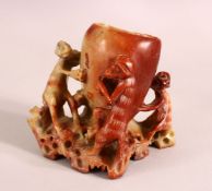A GOOD CHINESE CARVED SOAPSTONE BRUSH WASH, the body carved with monkeys, 12cm high, 13cm wide.