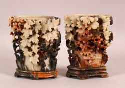 A PAIR OF CHINESE CARVED SOAPSTONE VASES - each carved in relief depicting flora -- each mounted