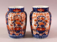 A PAIR OF JAPANESE MEIJI PERIOD PORCELAIN IMARI VASES, with ribbed body and floral panel decoration,