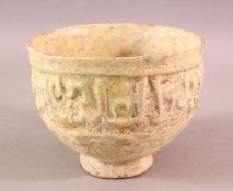 A KUFIC SCRIPT GLAZED POTTERY BOWL, the exterior with moulded script, 15cm diameter,