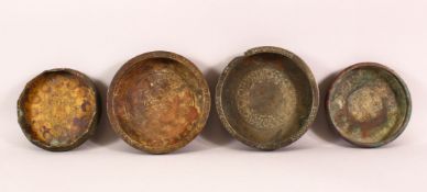 A COLLECTION OF FOUR ISLAMIC POSSIBLY 13TH CENTURY BRONZE DISHES, each engraved with calligraphy,
