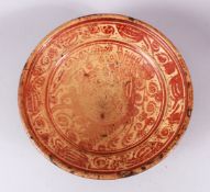 A 16TH CENTURY LARGE HISPANO - MORESQUE COPPER LUSTRE POTTERY DISH, decorated with a copper lustre