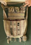 A CHINESE MINORITY PEOPLE'S WEAVING TASSELLED SHOULDER BAG, 14in x 10ins.