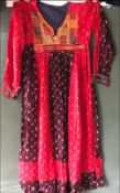 AN AFGAN DRESS, 20th Century, decoratively embroidered front panel and cuffs, waist approx 32in,