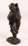 A JAPANESE MEIJI PERIOD BRONZE OKIMONO OF A MAN & MONKEY, the man stood with a monkey upon his