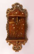 A CARVED WOOD & LACQUER CHINESE WALL SHELF UNIT, with twin folding shelves, the panel decorated with