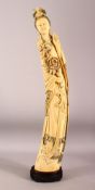 AN IMPRESSIVE LARGE CHINESE IVORY TUSK CARVING OF A STANDING GUANYIN, her left hand raised, her