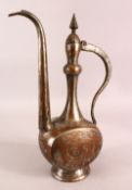 AN ISLAMIC TINNED COPPER EWER, the body with engraved decoration, 39cm high.