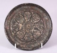 A 19TH CENTURY BIDRI CIRCULAR DISH, inlaid a radiating foliate design, 17cm diameter.