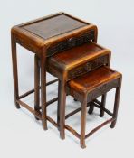 A GOOD NEST OF THREE CHINESE HARDWOOD TABLES, each with carved frieze, largest 60cm high, 43cm wide,