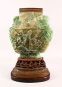 A LARGE AND IMPRESSIVE CHINESE CARVED GREEN QUARTZ VASE / LAMP, on a carved hardwood peach formed