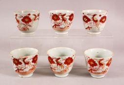 A SET OF SIX ARITA PORCELAIN CUPS, each painted with iron red bird amongst flowers, each approx. 7cm