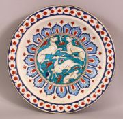 A LARGE TURKISH IZNIK POTTERY PLATE - decorated central with animals around floral motif - 31cm