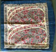 AN EARLY 19TH CENTURY KASHMIR SHAWL FRAGMENT mounted as a cushion cover.