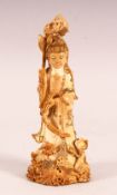 A CHINESE CARVED & POLYCHROME DECORATED IVORY FIGURE OF GUANYIN - stood holding flora and surrounded