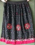 AN INDIAN BLACK SILK SKIRT AND SHAWL SET, each with embroidered and mirrored decoration, skirt waist