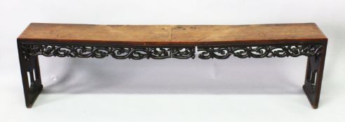 A CHINESE HARDWOOD BENCH SEAT with pierced and carved frieze and end supports, 187cm long, 27cm