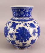 AN 18TH CENTURY BLUE & WHITE POTTERY VASE - decorated with scrolling floral roundel - 26cm