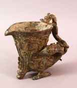 A CHINESE ARCHAIC BRONZE LIBATION CUP, the handle in the form of a dragon, 12cm high.