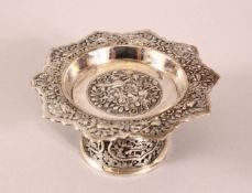 A 19TH CENTURY CHINESE SILVER STEM DISH - Decorated with relief of birds and foliage - 11cm