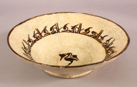 A SMALL NISHAPUR GLAZED POTTERY BOWL, the inner with a band of kufic script, the centre painted with