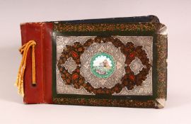 A PERSIAN LACQUER, WHITE METAL & ENAMEL ARTIST BOOK - the cover with in inset enamel plaque of a