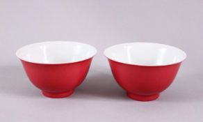 A PAIR OF 19TH / 20TH CENTURY CHINESE RUBY RED GLAZED PORCELAIN TEA BOWLS, with a ruby red / pink