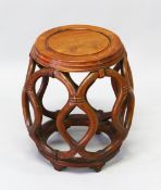 A CHINESE HARDWOOD BARREL SEAT, with lattice work sides, 30cm diameter, 45cm high.