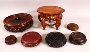 A MIXED LOT OF 7 19TH CENTURY CHINESE CARVED HARDWOOD STANDS - the larger of unusual lotus form with