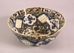 A 19TH CENTURY OR EARLIER TURKISH POTTERY BOWL, with floral motif decorations, (af) 18.5cm