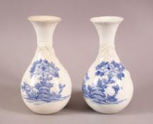 A PAIR OF JAPANESE HIRADO BLUE AND WHITE BOTTLE VASES, with moulded and painted decoration, 18cm