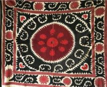A HAND EMBROIDERED BLACK AND RED WALL COVERING / BEDSPREAD, circa 1920, Tashkent Susani, 5ft x 4ft