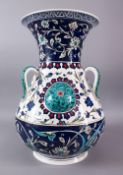 A LARGE TURKISH OTTOMAN STYLE CERAMIC FLORAL LAMP VASE, with three moulded handles and three bosses,