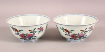 A PAIR OF 19TH / 20TH CENTURY CHINESE DOUCAI DECORATED BOWLS - each decorated with floral display