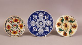 A MIXED LOT OF THREE TURKISH KUTAHYA POTTERY PLATES - one blue & white 18cm & two approx. 14cm