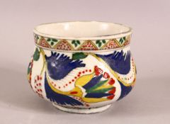 A TURKISH KUTAHYA POTTERY DECORATED BOWL - decorated with multi coloured glaze depicting flora and