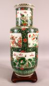 A CHINESE FAMILLE VERTE PORCELAIN VASE ON STAND - The body of the vase decorated with panels of