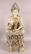 A LARGE CHINESE PORCELAIN FIGURE OF GUANYIN - Seated upon stylized waves with two young