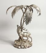 A VERY GOOD PLATED CENTREPIECE, a stag standing beneath a palm tree. 17ins high.